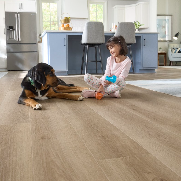 Child and family dog playing on waterproof Pergo Flooring