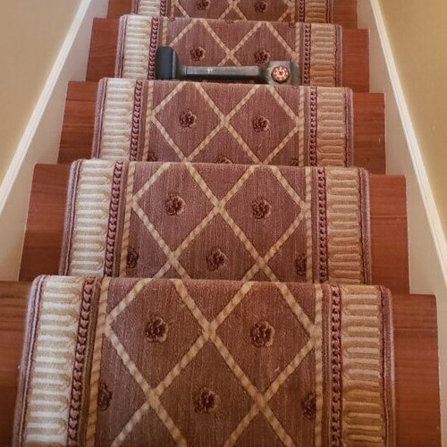 Vintage stair runner installed on wood stairs